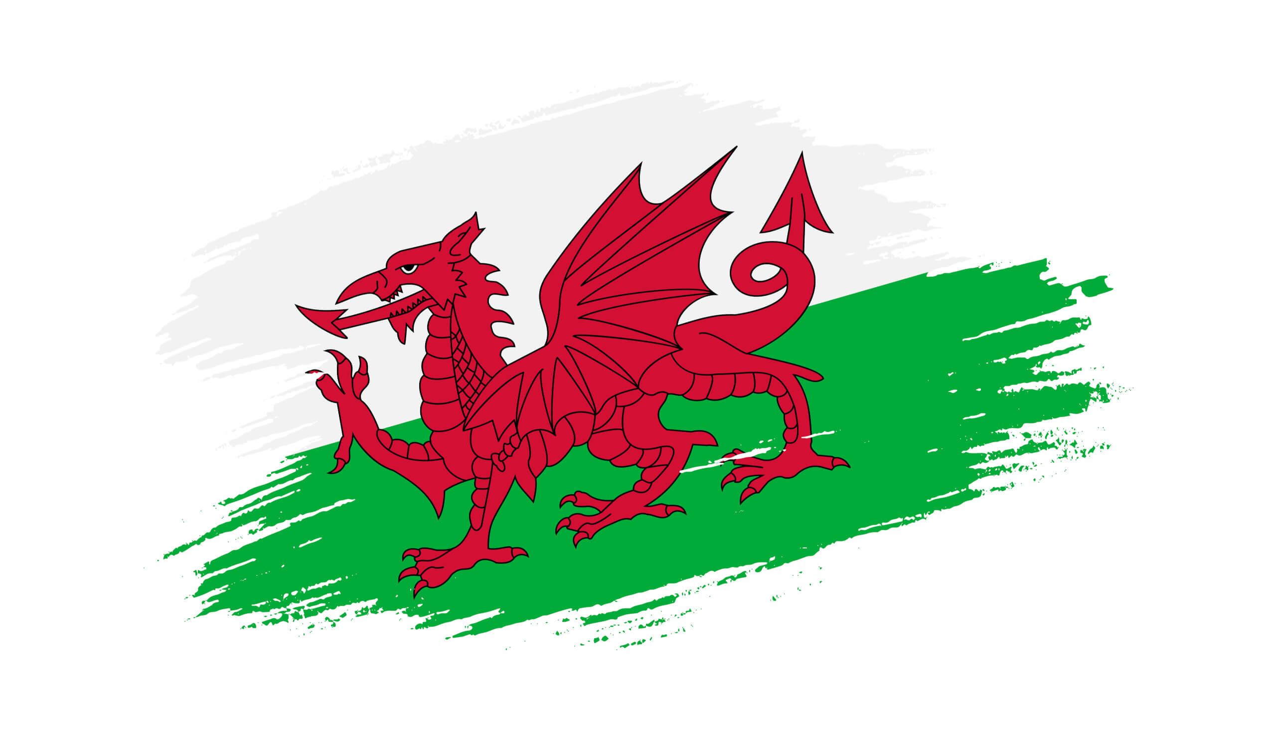 Das Bild zeigt die walisische Flagge mit einem roten Drachen auf grünem und weißem Hintergrund.
