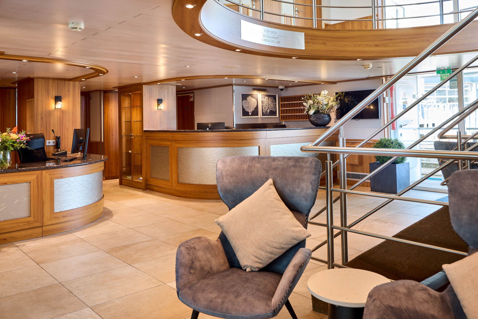 Ein eleganter Empfangsbereich mit Holzvertäfelungen, modernen Stühlen und einer freundlichen Atmosphäre.